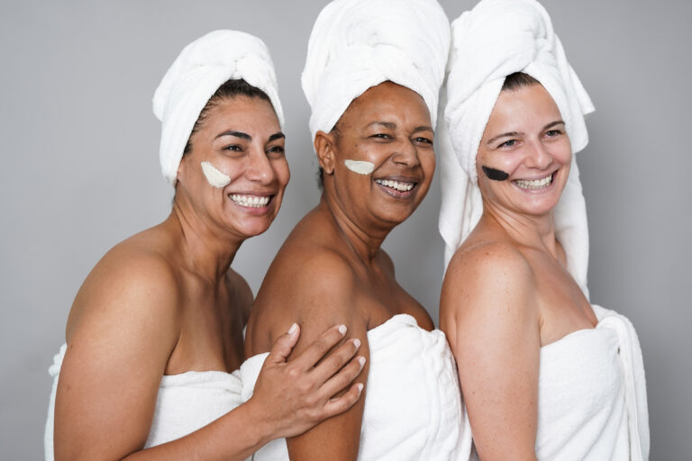 Multiracial mature women doing beauty treatment skin care togeth